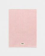 Pink textured mat with 'Tekla' branding on a light gray background