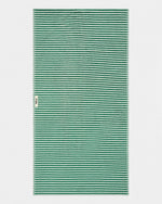 A rectangular woven textile with a repeating horizontal stripe pattern in green and off-white, shown flat against a light gray background. A small side tag is visible on the left edge.