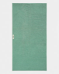 A rectangular woven textile with a repeating horizontal stripe pattern in green and off-white, shown flat against a light gray background. A small side tag is visible on the left edge.