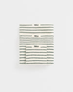 Three striped towels with 'Tekla' branding on a white background