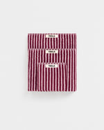 Three striped towels with 'Tekla' labels on a white background