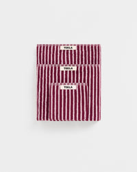 Three striped towels with 'Tekla' labels on a white background
