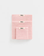 Pink striped fabric with 'Tekla' label on a white background