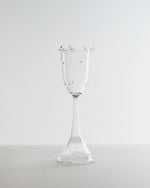 Clear glass goblet on a white background