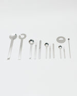 Set of silver spoons and tools on a white background