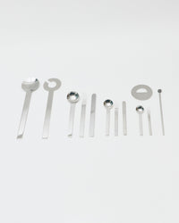 Set of silver spoons and tools on a white background