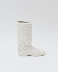 White textured boot on a light gray background