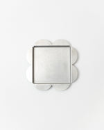 Decorative tray with clover-shaped edges on a white background