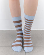 Striped socks worn by a person on a light background