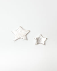 Star-shaped silver objects on a white background
