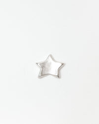 A small, five-pointed star-shaped ceramic with a silver finish, centered on a plain white background.