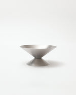 Silver bowl with textured design on a white background