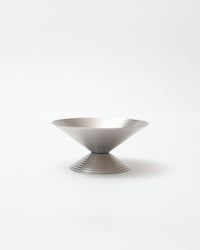 Silver bowl with textured design on a white background
