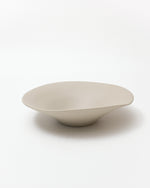 Beige ceramic bowl on a white background