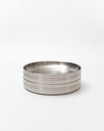 Stack of metal plates on a white background
