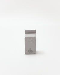 Gray soap packaging with text on a white background