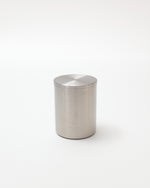 Silver cylindrical container on a white background