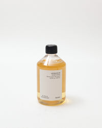 Bottle of hand wash refill with a black cap on a white background