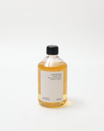 Bottle of liquid with a black cap on a white background
