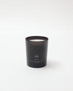 Black candle with a visible brand logo on a white background