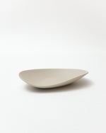 Beige ceramic bowl on a white background