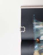 Close-up of a book with a black cover on a white background