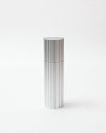 Silver cylindrical object on a white background