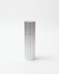 Silver cylindrical object on a white background