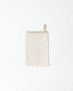Beige body scrub mitt on a white background