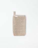 Textured beige body scrub on a white background