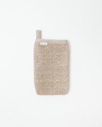 Textured beige body scrub on a white background