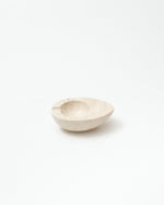 Small beige ceramic bowl on a white background