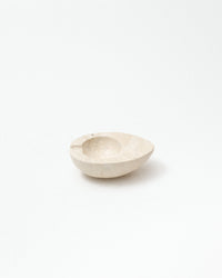 Small beige ceramic bowl on a white background