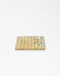 Rectangular soap dish with textured surface on a white background