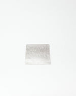 Square tile with a grayish-white pattern on a white background