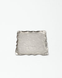 Silver textured square dish on a white background