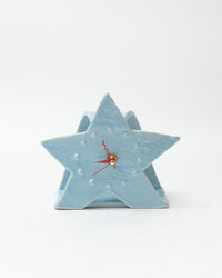 Star-shaped clock with a blue finish on a white background
