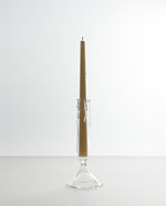 Candle in a glass holder on a white background
