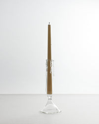 Candle in a glass holder on a white background