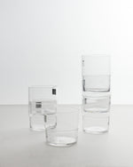 Set of clear glass tumblers on a white background