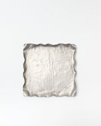 Silver textured square dish on a white background