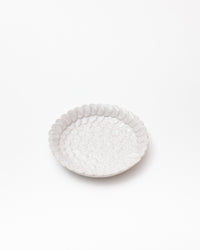 White textured ceramic plate on a white background
