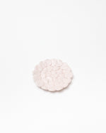 Round pink pebble stone on a white background