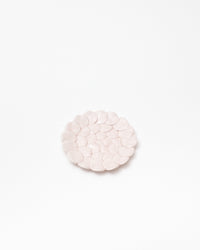 Round pink pebble stone on a white background