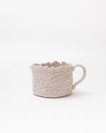 White textured mug on a white background