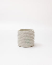Textured ceramic planter on a white background
