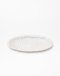 White textured oval platter on a white background
