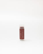 Lip balm stick with 'F. Miller' branding on a white background