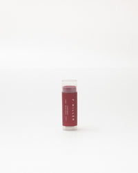 Lip balm stick with visible brand name on a white background