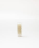 Small cylindrical container with a white background